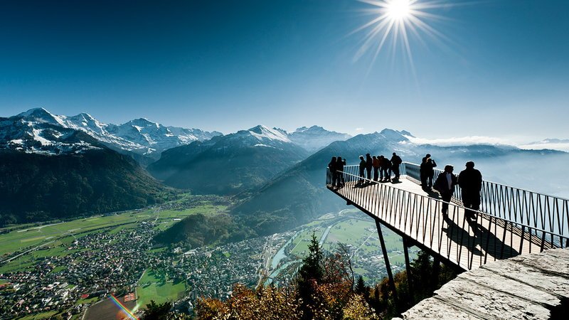 Panoramic view of Lake Thun and Lake Brienz from the Harder Kulm viewpoint in Interlaken, with the Swiss Alps